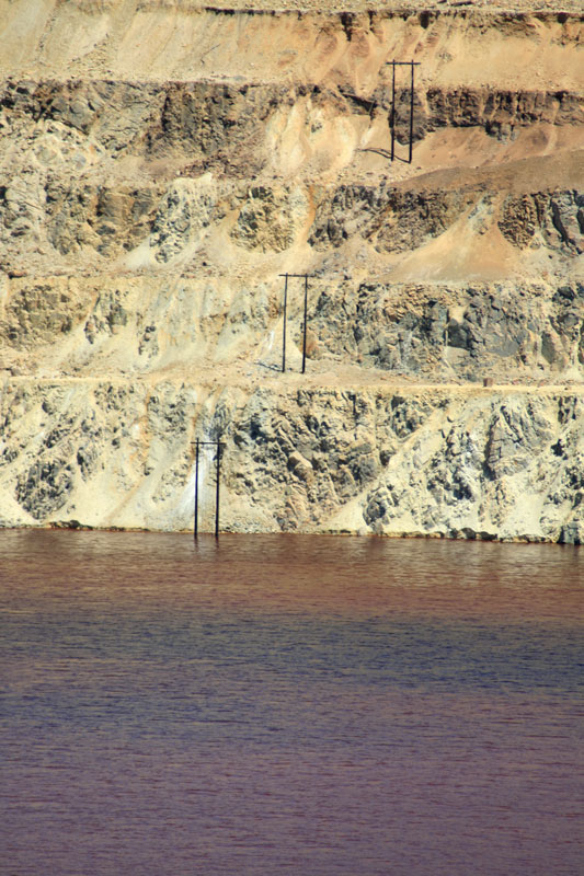 Berkeley Pit water quality has shown changes over time. It is regularly monitored by the Montana Bureau of Mines & Geology. The reddish color typically observed is due to high concentrations of iron solids. Photo by Justin Ringsak, 2009.
